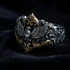 Baroque Raven Crest Ring close-up, raven relief and 18K gold-accented scrollwork