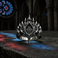 Basilica Rosette Ring in oxidized sterling silver, front view on a stone ledge with cathedral stained glass