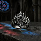 Basilica Rosette Ring in oxidized sterling silver, front view on a stone ledge with cathedral stained glass