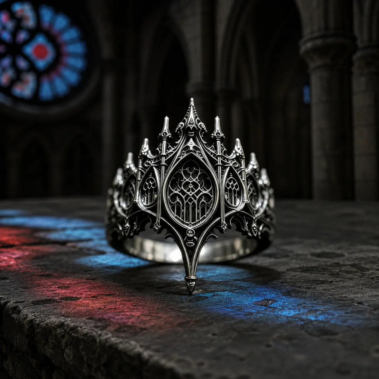 Basilica Rosette Ring in oxidized sterling silver, front view on a stone ledge with cathedral stained glass