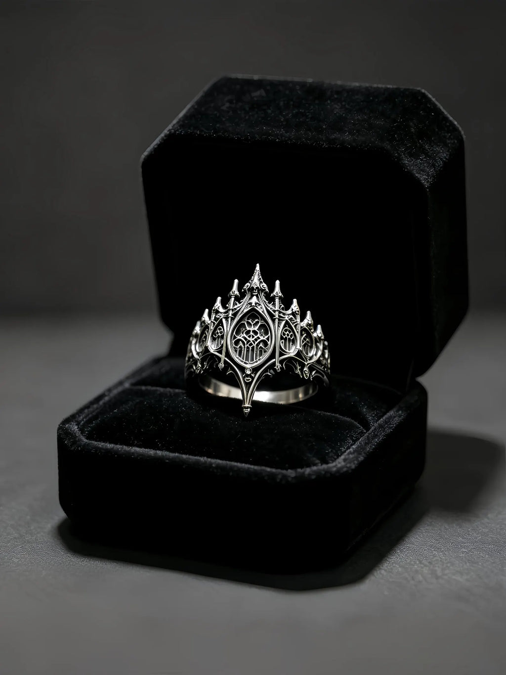 Basilica Rosette Ring presented in a black velvet ring box with candles