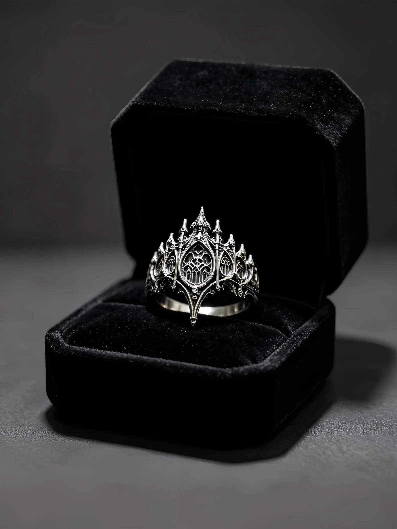 Basilica Rosette Ring presented in a black velvet ring box with candles