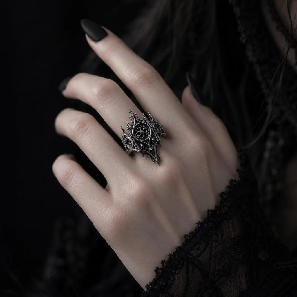 Hand wearing gothic cathedral rose window crown ring — alternative engagement ring with shadow crown silhouette
