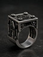 Side view of the Lord's Signet ring's carved Gothic cathedral window and buttresses in oxidized silver