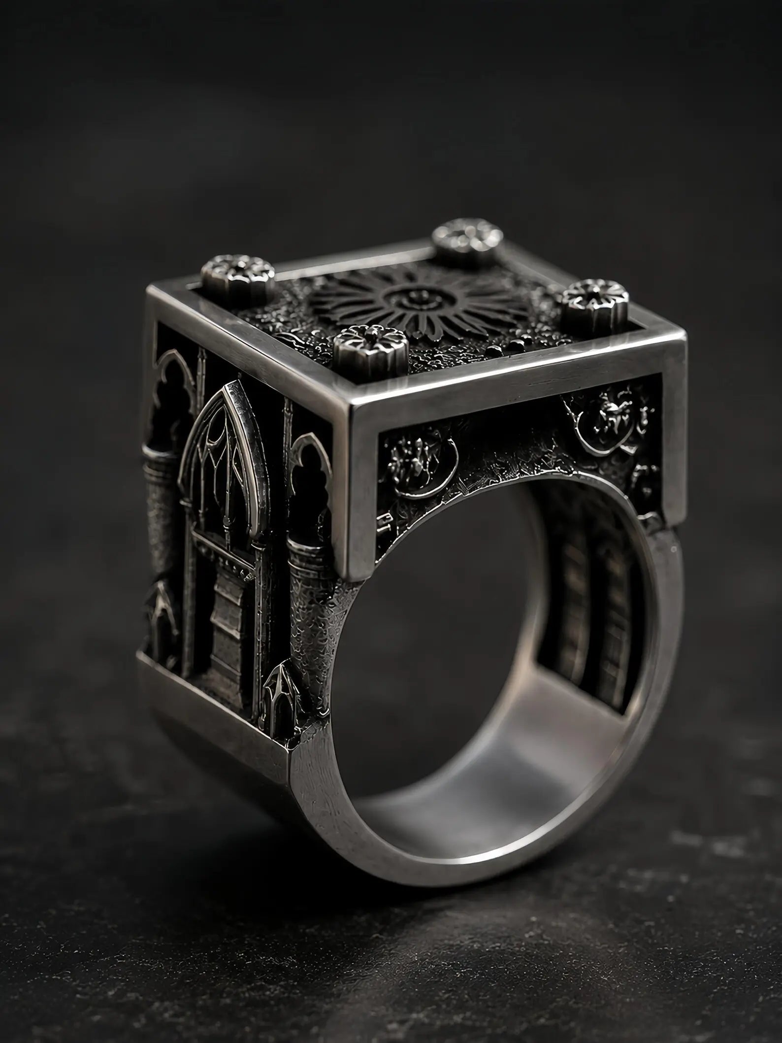 Side view of the Lord's Signet ring's carved Gothic cathedral window and buttresses in oxidized silver