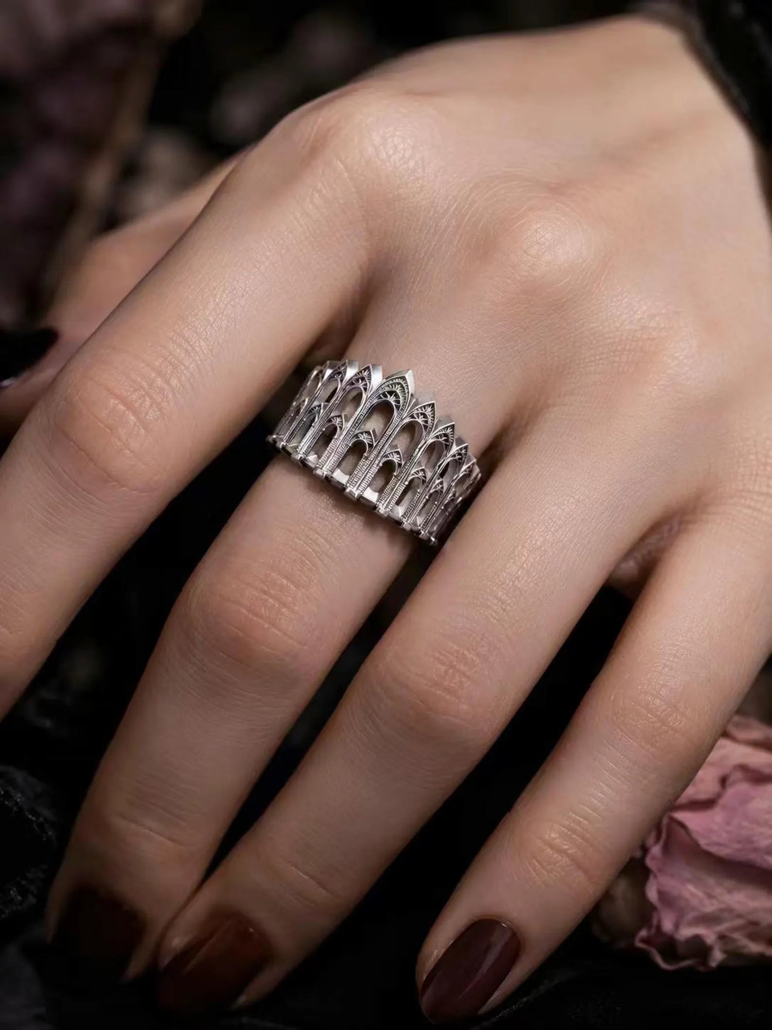 Cathedral Arcade Ring worn on a hand, showing the arcade band from above