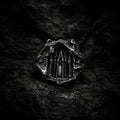 Dark Cathedral Ring — a miniature Gothic cathedral façade carved into raw oxidized 925 sterling silver, front view on dark rock