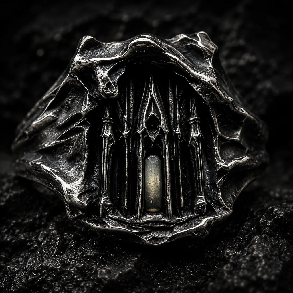 Close-up of the Dark Cathedral Ring's micro-cathedral façade with a lit central window in hand-worked silver