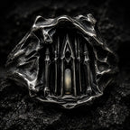 Close-up of the Dark Cathedral Ring's micro-cathedral façade with a lit central window in hand-worked silver