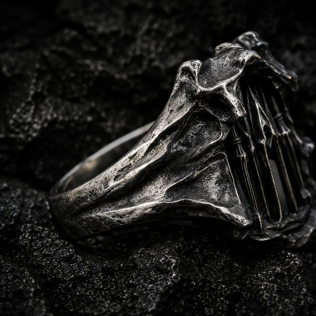 Angled view of the Dark Cathedral Ring showing the rough-hewn sculptural oxidized silver frame