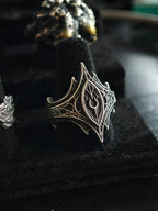 Angled view of the Relic Prophecy Ring on a display stand, hand-carved oxidized 925 sterling silver