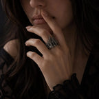 Woman wearing gothic cathedral crown ring — sterling silver statement ring in dark moody lifestyle shot