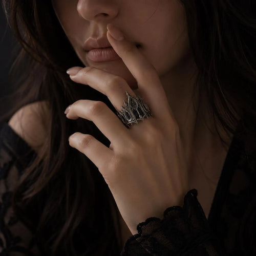 Woman wearing gothic cathedral crown ring — sterling silver statement ring in dark moody lifestyle shot