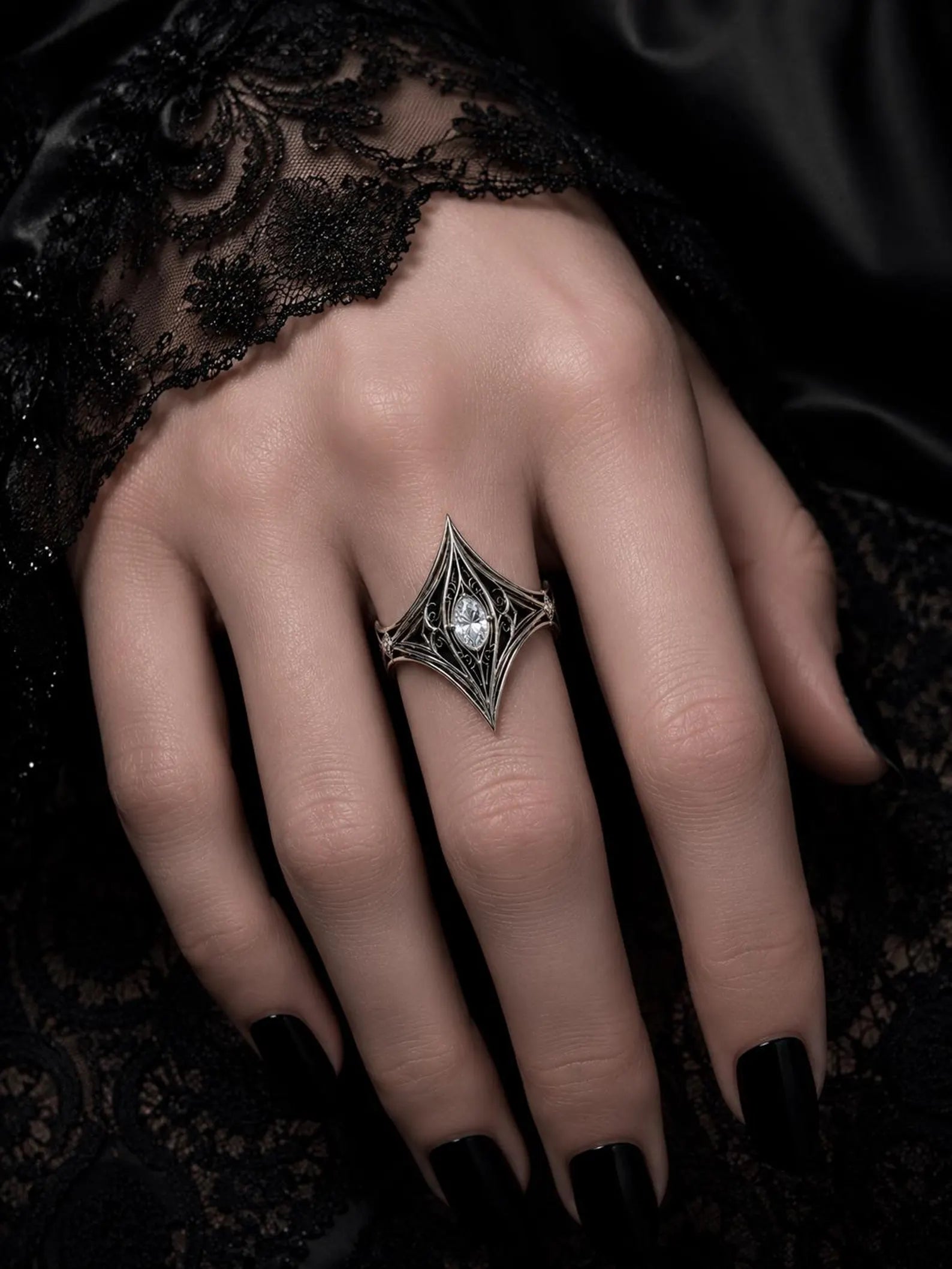 Elven Tear Ring worn on the hand, showing the filigree spire and marquise center stone