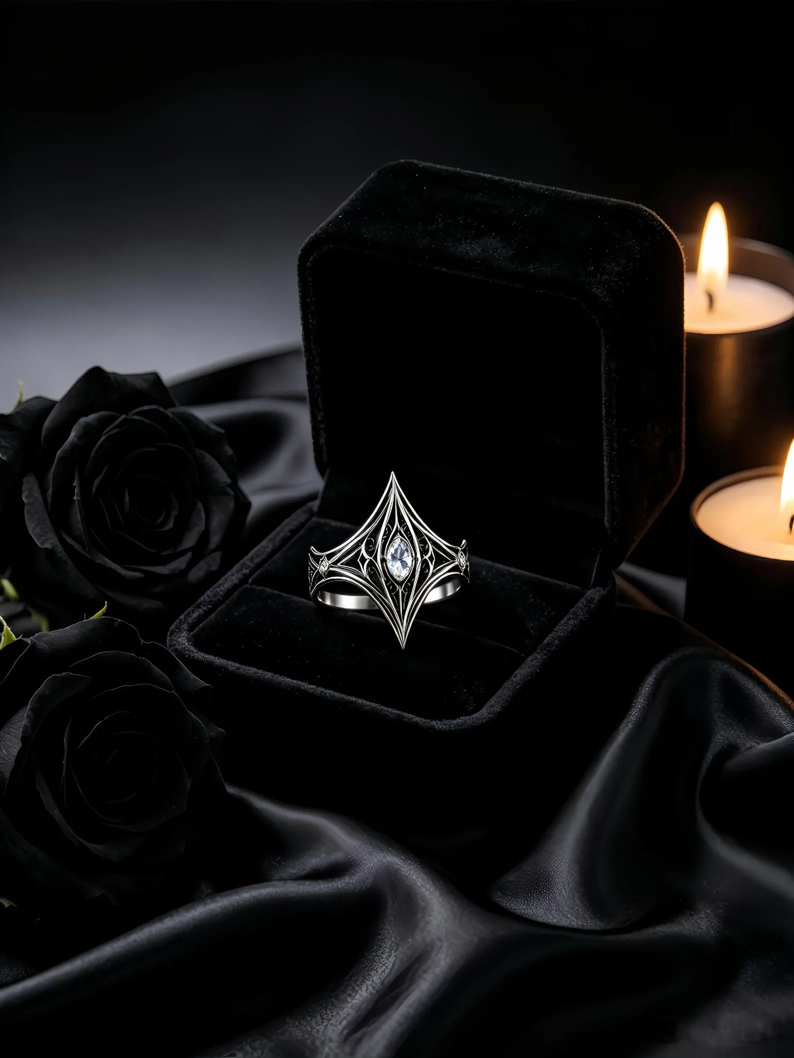Elven Tear Ring presented in a black velvet ring box with candles and black roses