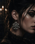 Spine motif dangle earring worn in ear, close-up
