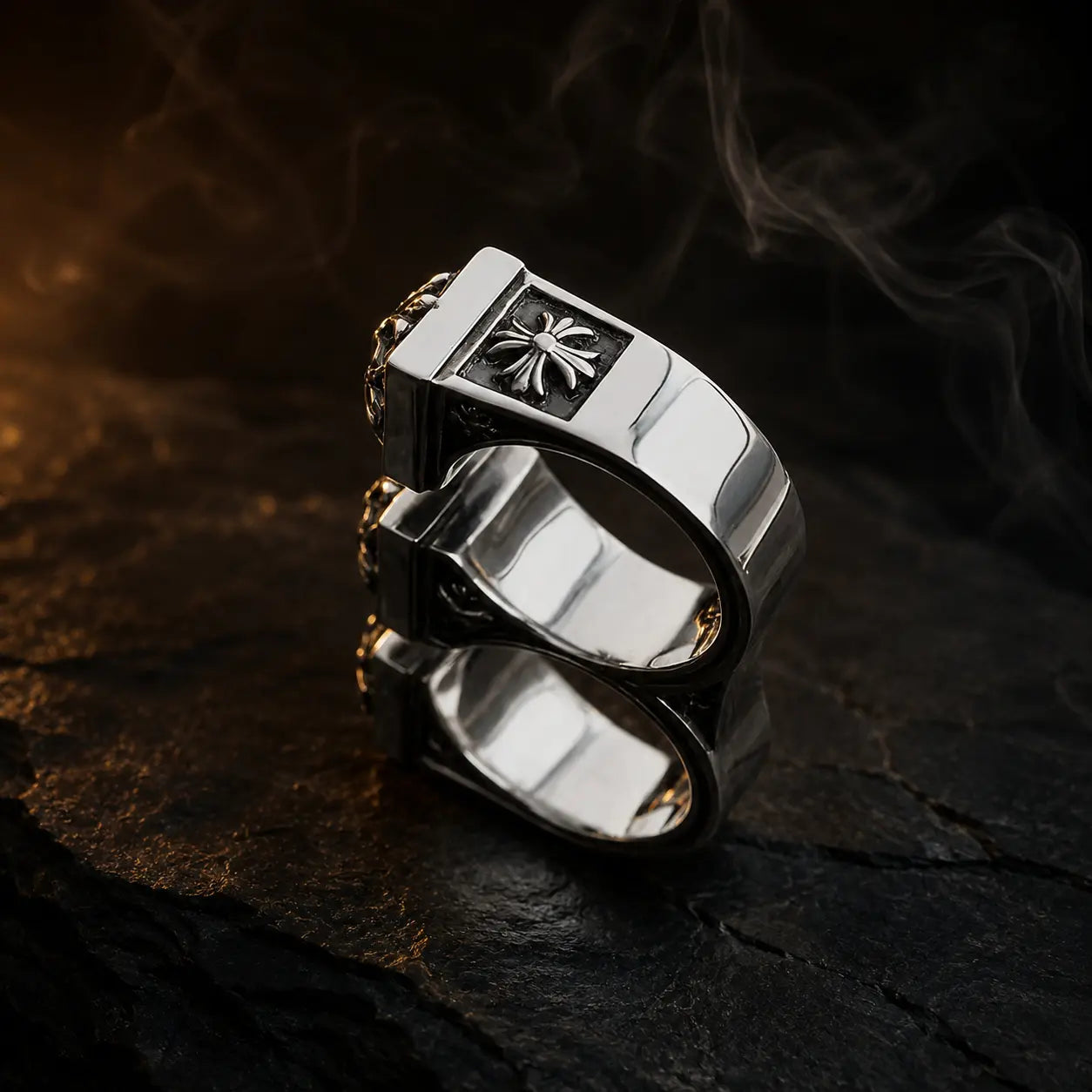 Double Fleur-de-Lis Ring worn across two fingers, side view showing fleur-de-lis and cross detail