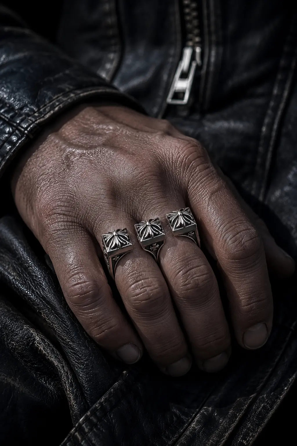 Double Fleur-de-Lis Ring held in hand showing oxidized silver texture and scale