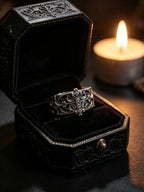 Sanctum Tracery Ring displayed in an ornate black ring box beside a candle