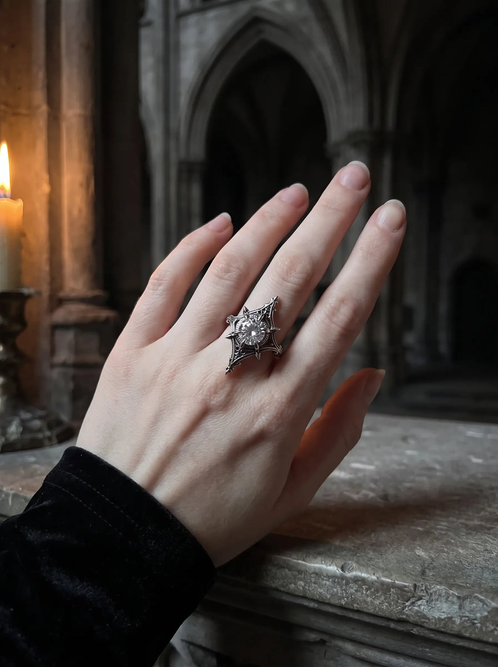 Midnight Star Neo-Gothic ring worn on hand, moissanite stone, in a gothic cathedral setting