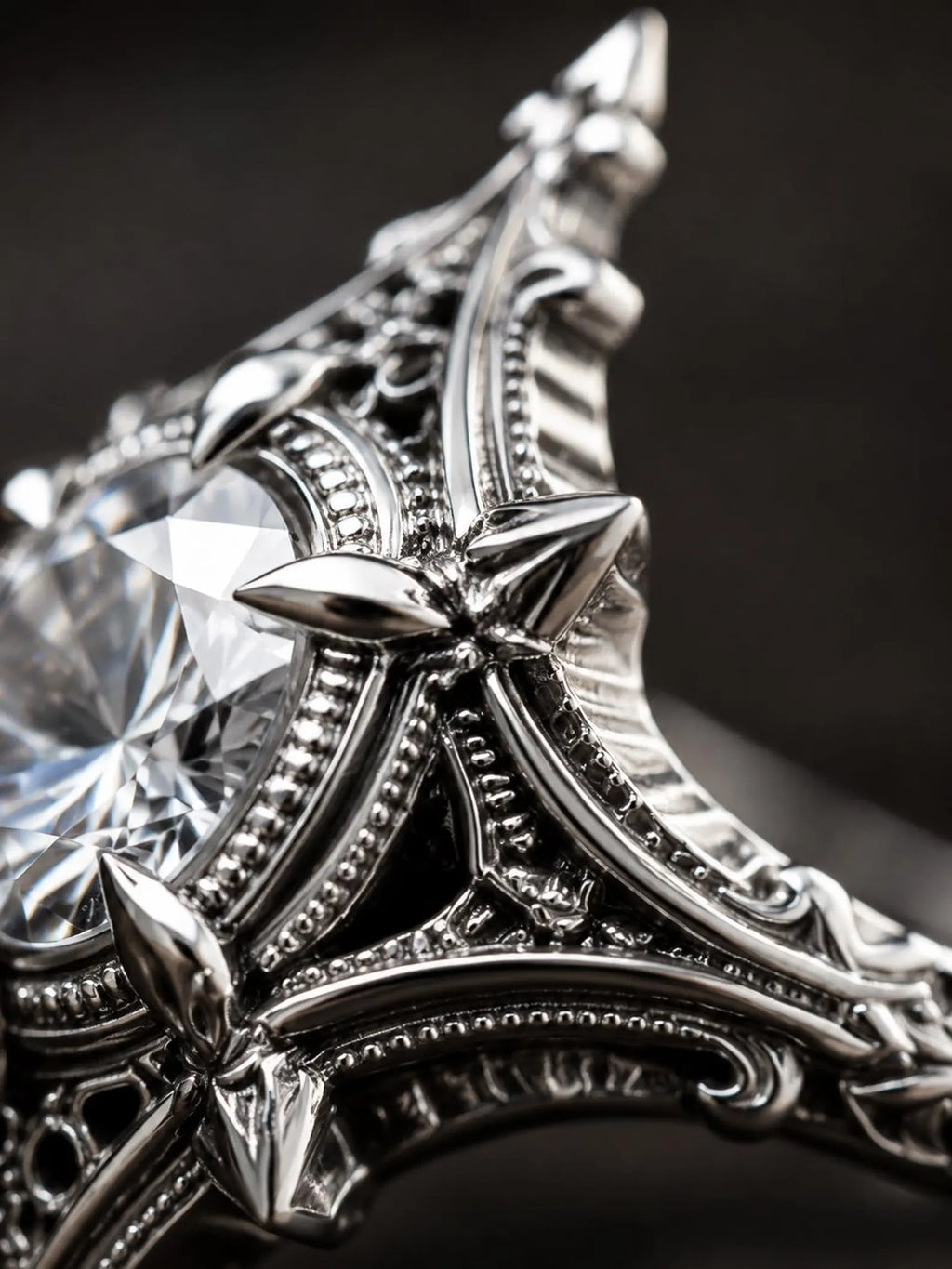 Macro detail of the oxidized sterling silver filigree and cross motifs on the Midnight Star Neo-Gothic ring