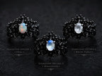 Dark Bloom Ring detail — iridescent oval stone framed by black sterling silver thorns