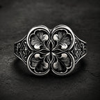 Gothic clover ring — sterling silver quatrefoil engraving, front view on dark stone backdrop