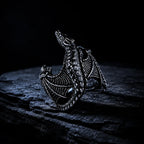 Close-up of Frost Dragon Ring scales and clawed feet detail in oxidized silver
