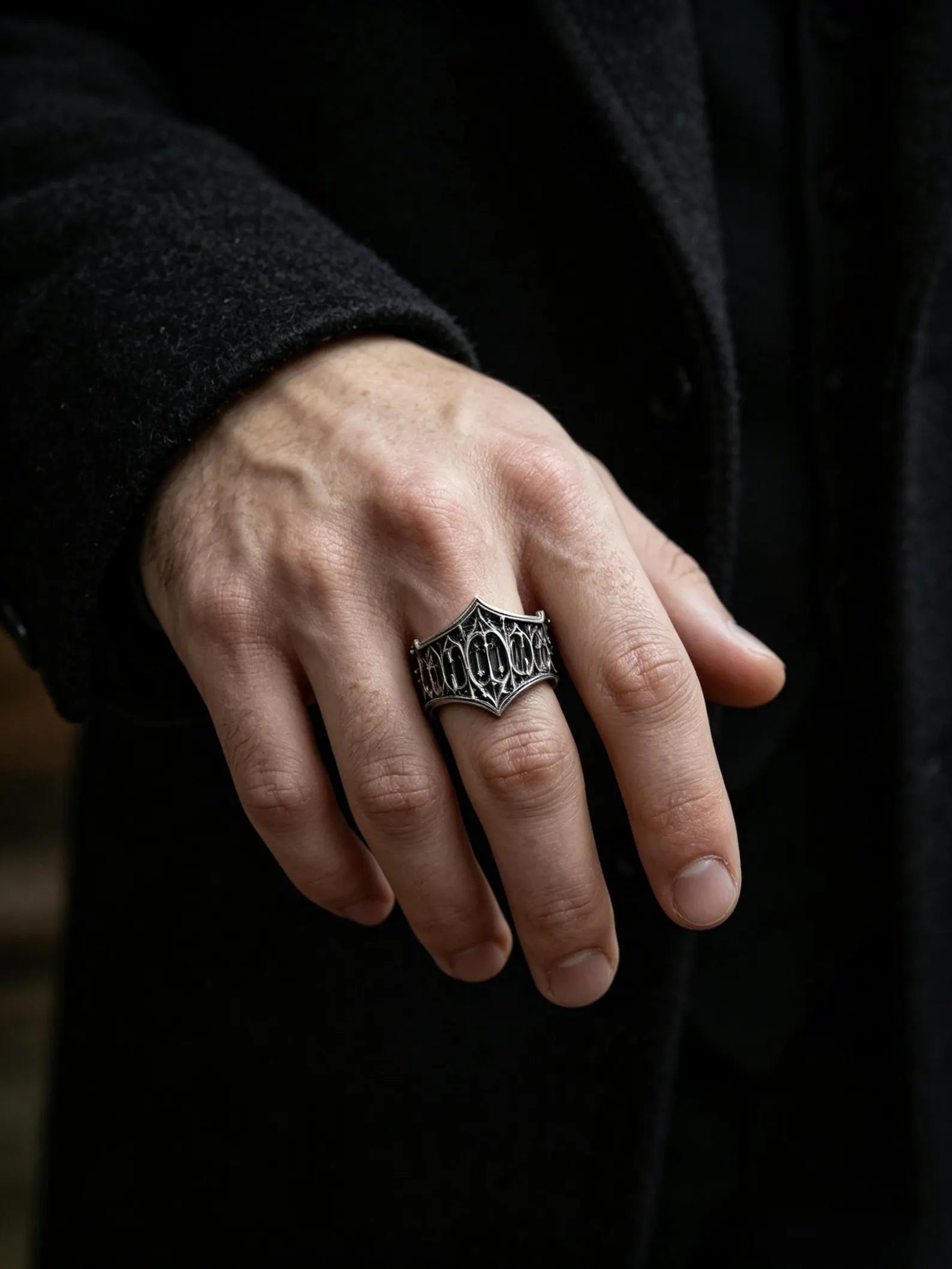 Man wearing the Cathedral Tracery Ring, a carved Gothic sterling silver band