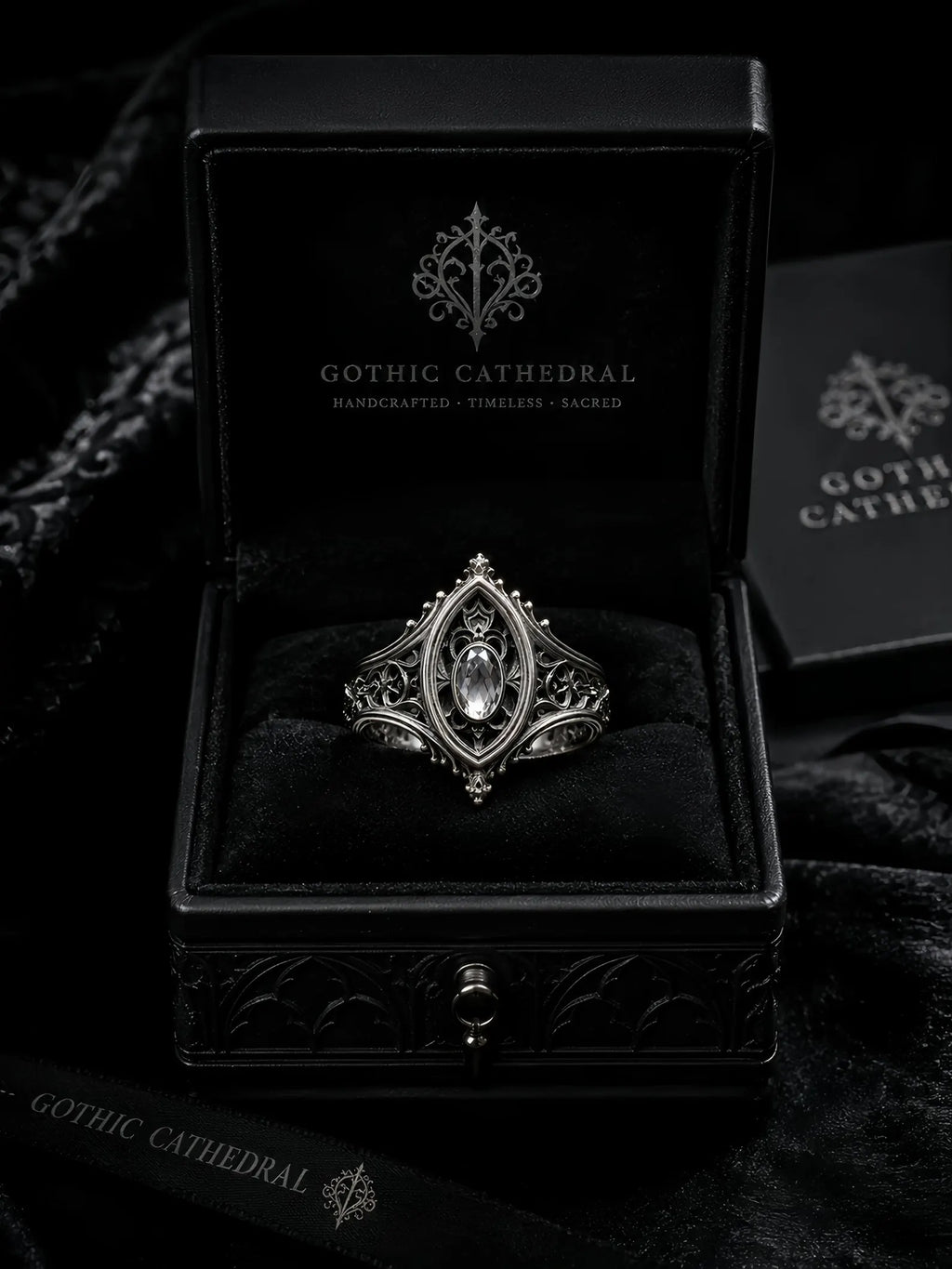 Sanctuary Window Ring detail, faceted stone catching light in silver tracery frame