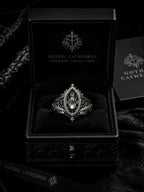 Sanctuary Window Ring detail, faceted stone catching light in silver tracery frame