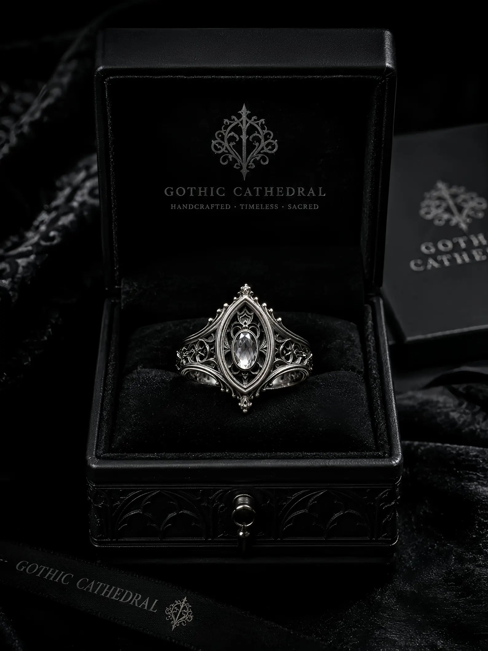 Sanctuary Window Ring detail, faceted stone catching light in silver tracery frame