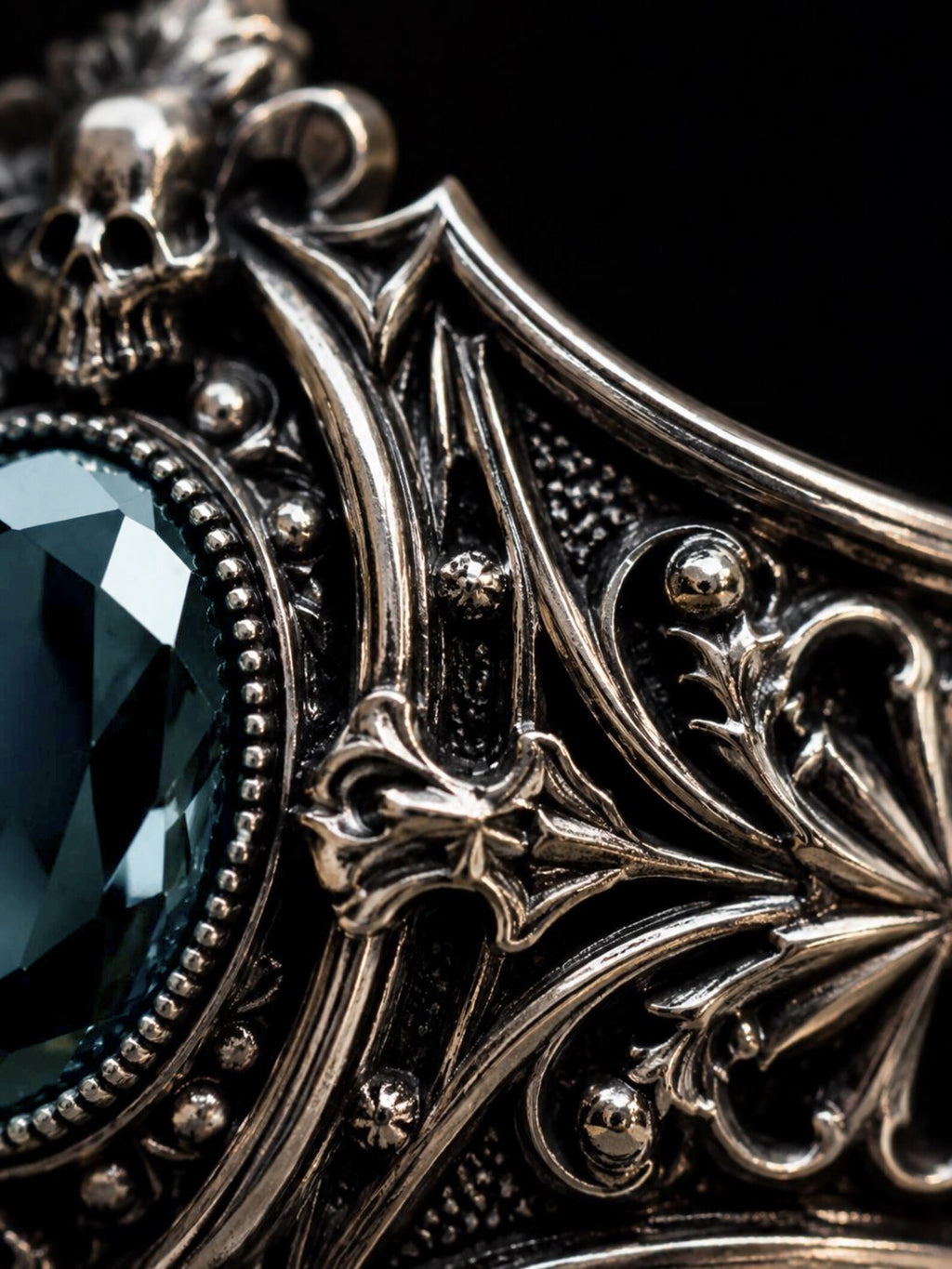 Victorian skull ring close-up — hand-sculpted skull motifs and chiaroscuro oxidized Baroque scrollwork